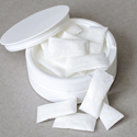 white container with nicotine pouches on plain grey surface and copy space